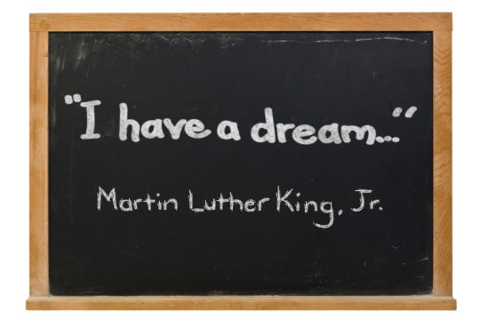 Cartoon of a chalkboard with the words “I have a dream…” written on it