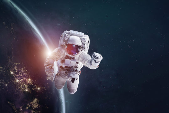 Astronaut floating in space with the Earth in the background.