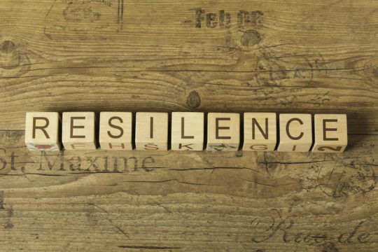 The word ‘Resilience’ spelled out in blocks on a wooden table