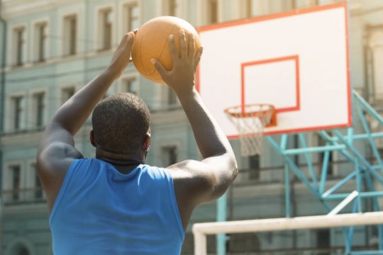 Man shooting basketball into a hoop