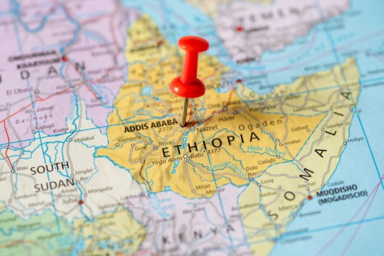 A close up of a map with a pin inside Ethiopia